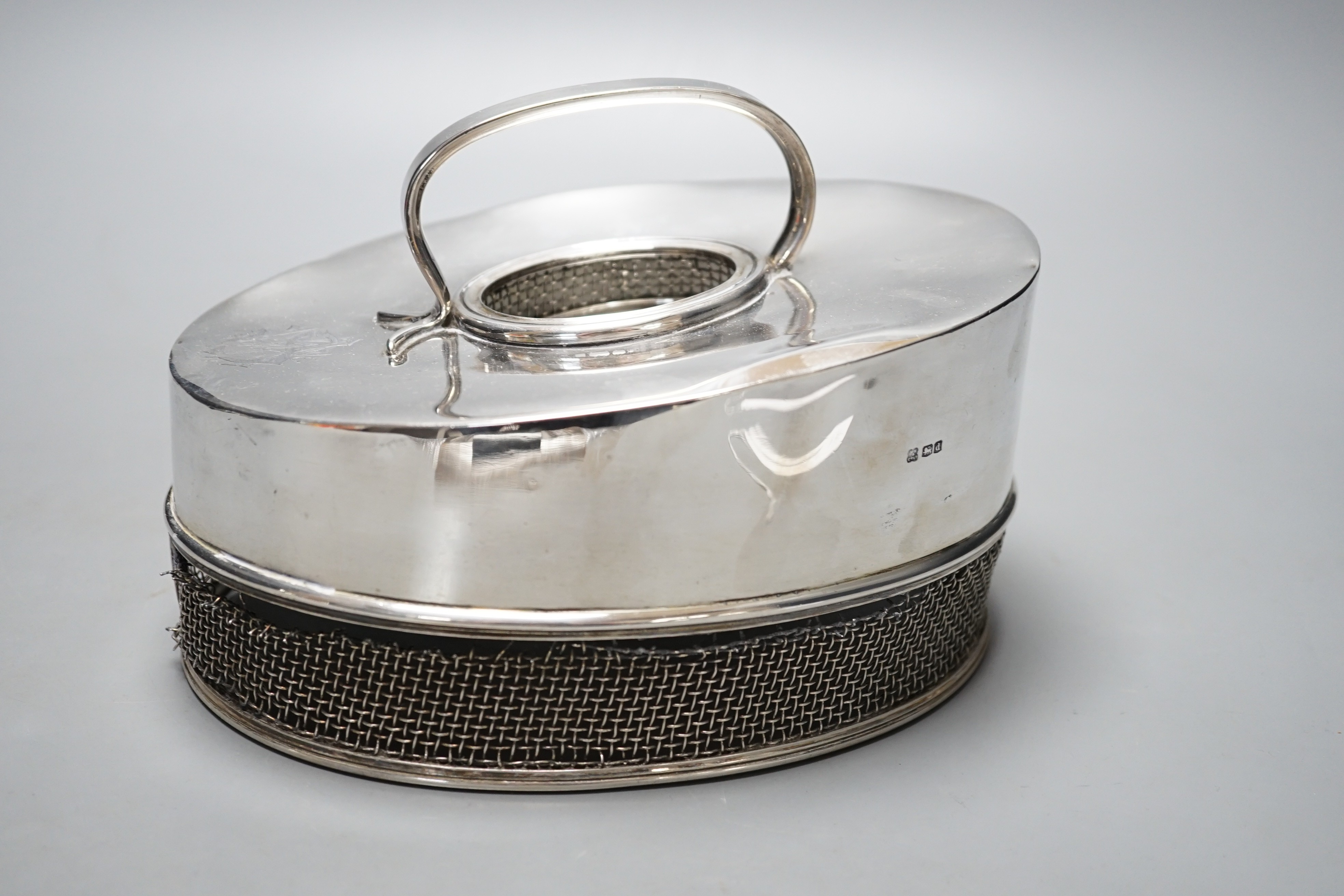 An unusual silver oval cheese dish cover, with mesh border, Martin, Hall & Co Ltd, Sheffield, 1921, 20.2cm, gross 21oz.